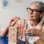 Older woman putting together a puzzle.