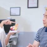 Man receives education about ear from doctor