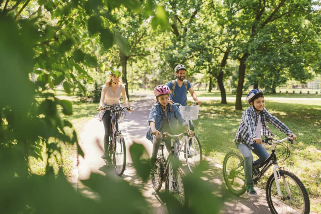 Family riding their bikes in the park.