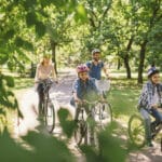 Family riding their bikes in the park