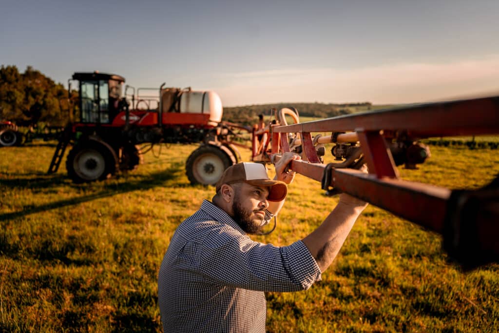 Farmer checking agricultural machinery parts