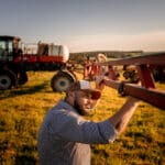 Farmer checking agricultural machinery parts