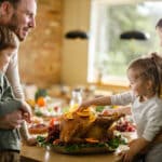 Happy family enjoying on Thanksgiving day in dining room