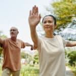 Practicing Tai Chi Outdoors on Sunny Day in Park
